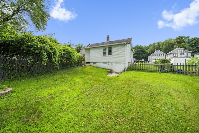 47 Park Ave, Enfield, CT 06002 - back of house featuring a fenced backyard and a chimney