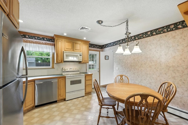 24 Westerly Dr, Enfield, CT 06082 - kitchen featuring stainless steel appliances, wallpapered walls, light flooring, a chandelier, and hanging light fixtures