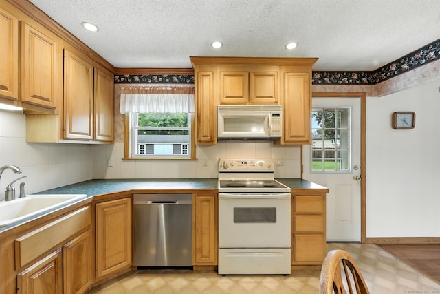 24 Westerly Dr, Enfield, CT 06082 - kitchen with white appliances, light flooring, decorative backsplash, recessed lighting, and dark countertops