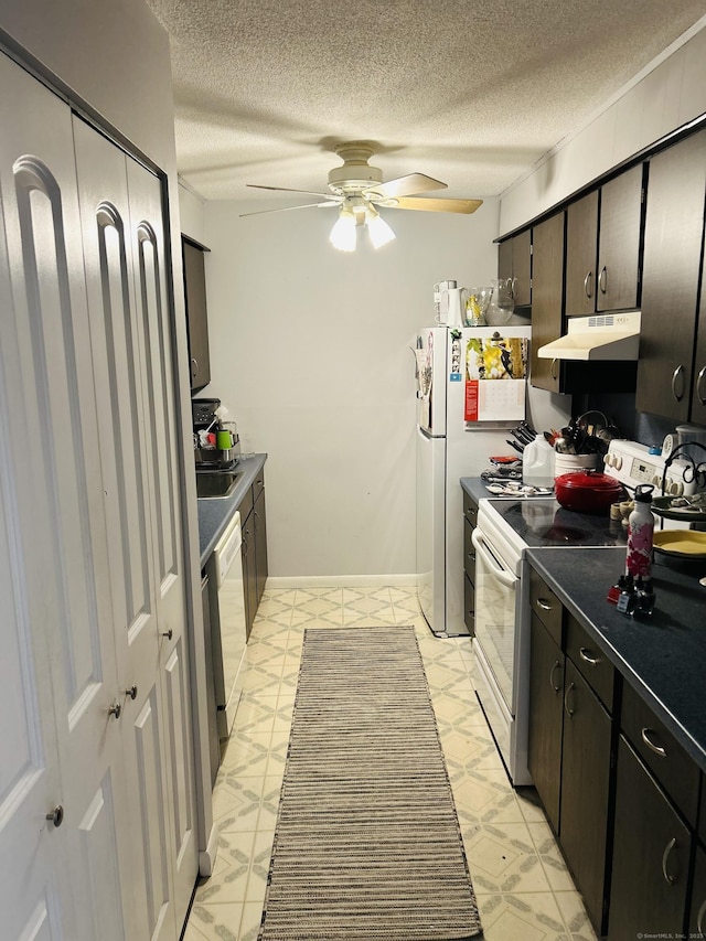 40 California St Unit A17, Stratford, CT 06615 - kitchen with white appliances, under cabinet range hood, dark countertops, ceiling fan, and a textured ceiling