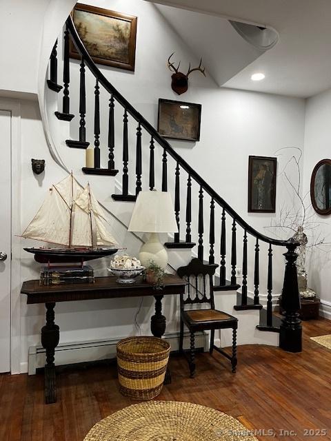 85 W Thames St, Norwich, CT 06360 - staircase with wood finished floors, a baseboard heating unit, baseboard heating, and recessed lighting
