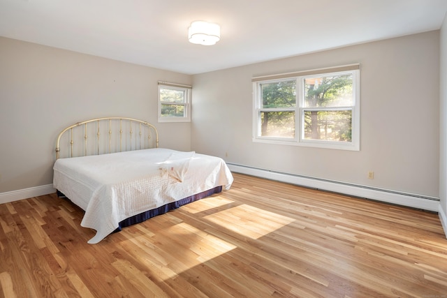 59 Judith Dr, Danbury, CT 06811 - bedroom with baseboard heating and wood finished floors