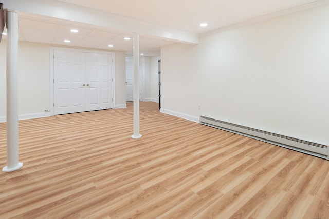 59 Judith Dr, Danbury, CT 06811 - finished basement with a baseboard heating unit, wood finished floors, recessed lighting, and crown molding