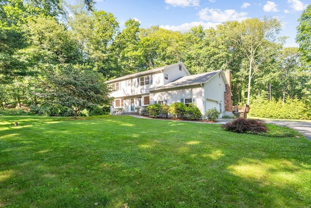 59 Judith Dr, Danbury, CT 06811 - view of front facade featuring a garage, a chimney, a front yard, and driveway