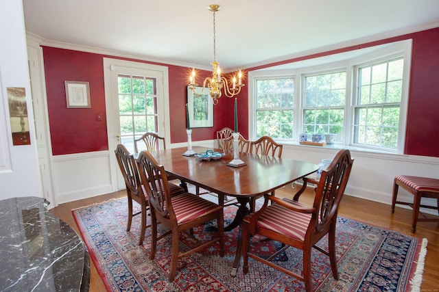23 Mountain View Dr, West Hartford, CT 06117 - dining space featuring a chandelier, wood finished floors, wainscoting, and ornamental molding