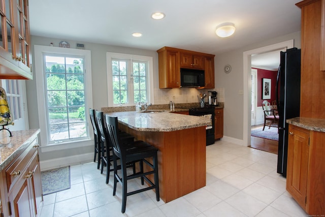 23 Mountain View Dr, West Hartford, CT 06117 - kitchen with black appliances, brown cabinetry, a peninsula, light tile patterned floors, and recessed lighting