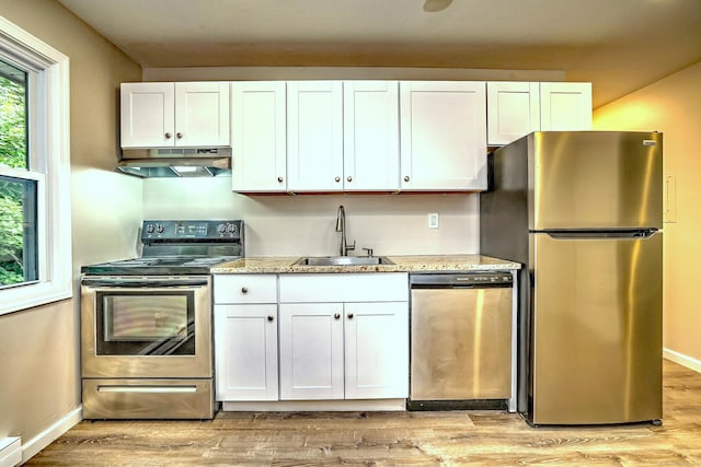 56 Wakelee Avenue Ext Unit 12, Shelton, CT 06484 - kitchen with stainless steel appliances, under cabinet range hood, white cabinetry, a baseboard heating unit, and light wood-style floors