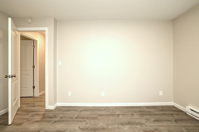 56 Wakelee Avenue Ext Unit 12, Shelton, CT 06484 - empty room featuring a baseboard heating unit and wood finished floors