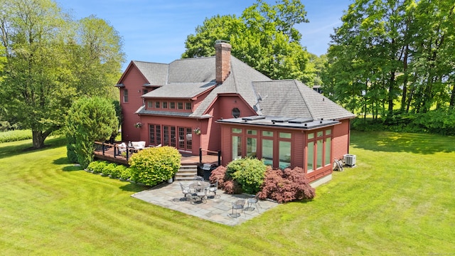 168 Sunset Hill Rd, Redding, CT 06896 - back of house featuring a patio, a wooden deck, a lawn, a chimney, and a sunroom