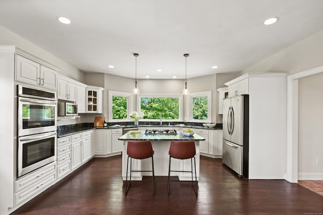 168 Sunset Hill Rd, Redding, CT 06896 - kitchen with a center island, appliances with stainless steel finishes, a kitchen bar, white cabinetry, and recessed lighting