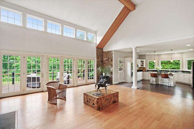 168 Sunset Hill Rd, Redding, CT 06896 - living room featuring decorative columns, high vaulted ceiling, wood finished floors, recessed lighting, and beamed ceiling
