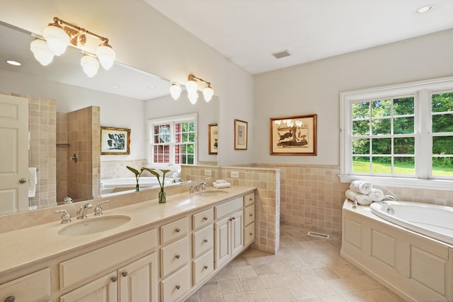 168 Sunset Hill Rd, Redding, CT 06896 - bathroom with a bath, double vanity, tile patterned floors, tile walls, and a wainscoted wall