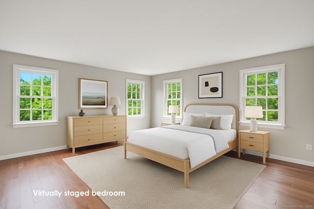 168 Sunset Hill Rd, Redding, CT 06896 - bedroom featuring multiple windows and wood-type flooring