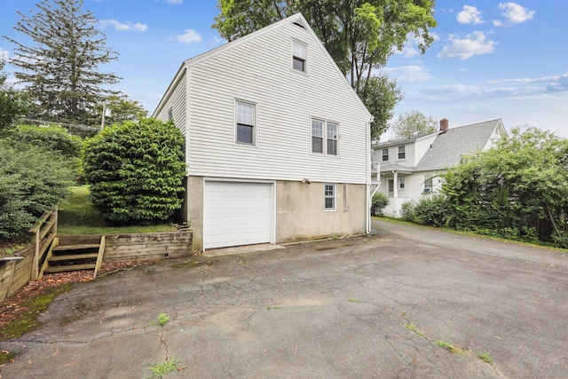 9 Fairfield Ave, Danbury, CT 06810 - view of side of home featuring asphalt driveway and a garage
