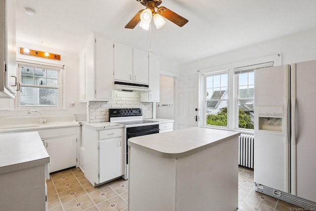 9 Fairfield Ave, Danbury, CT 06810 - kitchen with white refrigerator with ice dispenser, radiator, electric stove, under cabinet range hood, and plenty of natural light