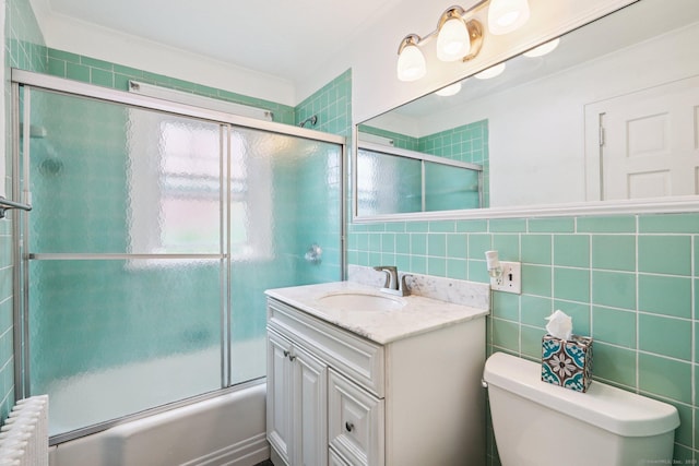 9 Fairfield Ave, Danbury, CT 06810 - full bath with radiator, shower / bath combination with glass door, tile walls, and vanity