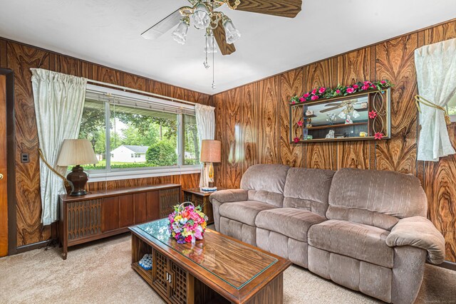 7 Weymouth Dr, Enfield, CT 06082 - carpeted living area with wood walls and ceiling fan