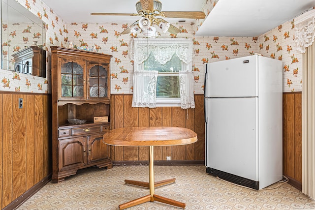 7 Weymouth Dr, Enfield, CT 06082 - dining space featuring a wainscoted wall, ceiling fan, wood walls, and wallpapered walls