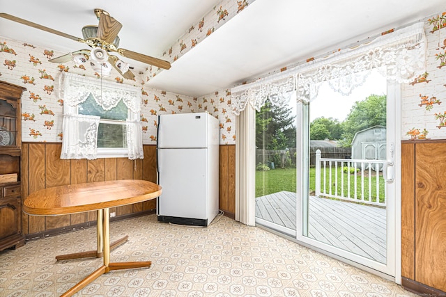 7 Weymouth Dr, Enfield, CT 06082 - kitchen with freestanding refrigerator, a ceiling fan, wainscoting, wallpapered walls, and wooden walls