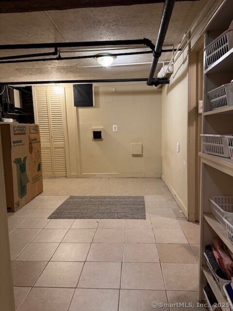 240 Walnut St, Windham, CT 06226 - finished basement featuring light tile patterned floors