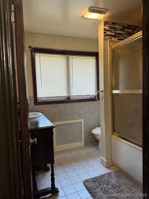 240 Walnut St, Windham, CT 06226 - bathroom with radiator, vanity, tile patterned flooring, healthy amount of natural light, and ornamental molding