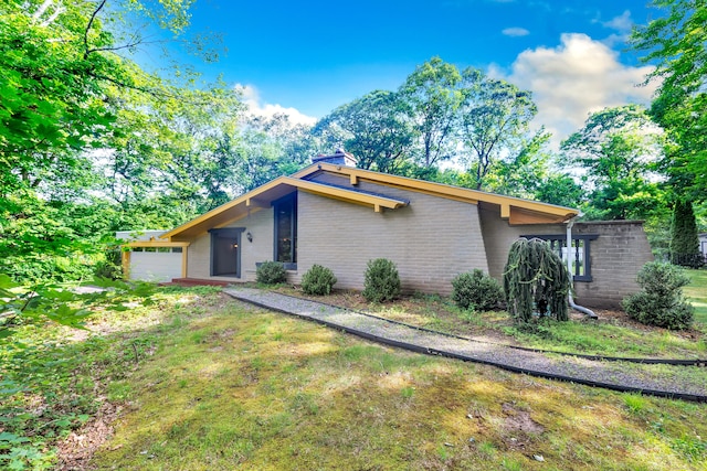 3 Yale Ave, Shelton, CT 06484 - view of side of home featuring brick siding, a garage, and a chimney
