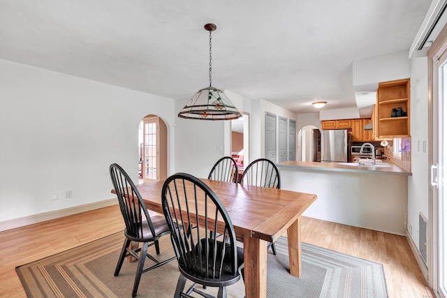 3 Yale Ave, Shelton, CT 06484 - dining space featuring arched walkways and light wood-type flooring