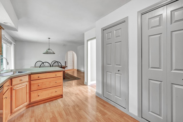 3 Yale Ave, Shelton, CT 06484 - kitchen featuring arched walkways, light wood finished floors, pendant lighting, light brown cabinets, and light countertops