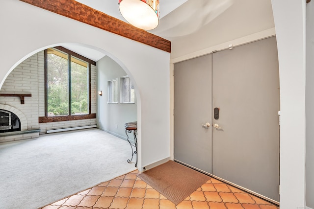 3 Yale Ave, Shelton, CT 06484 - carpeted foyer featuring a baseboard heating unit, arched walkways, and a fireplace