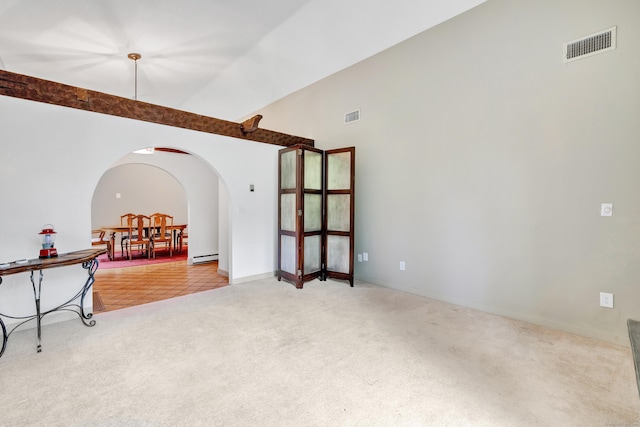 3 Yale Ave, Shelton, CT 06484 - carpeted empty room featuring arched walkways, a baseboard radiator, and high vaulted ceiling