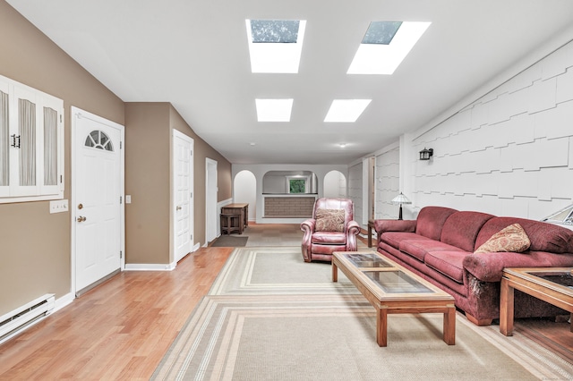 3 Yale Ave, Shelton, CT 06484 - living area featuring arched walkways, a baseboard heating unit, and light wood finished floors
