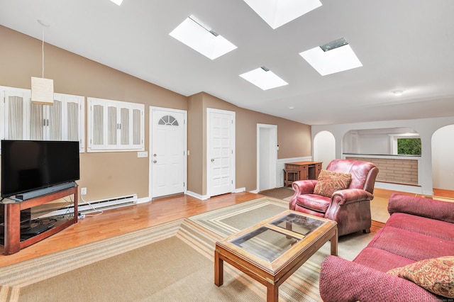 3 Yale Ave, Shelton, CT 06484 - living room featuring a skylight, wood finished floors, vaulted ceiling, and arched walkways