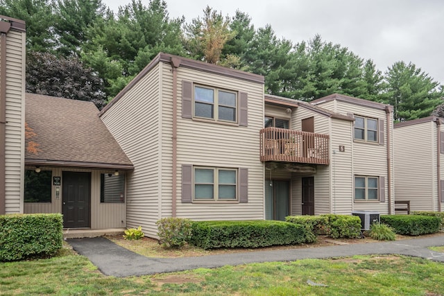 506 Twin Circle Dr Unit 506, South Windsor, CT 06074 - view of front facade featuring a balcony, a front lawn, a shingled roof, and a chimney