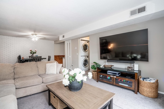 506 Twin Circle Dr Unit 506, South Windsor, CT 06074 - carpeted living area featuring stacked washer / drying machine, ceiling fan, and brick wall