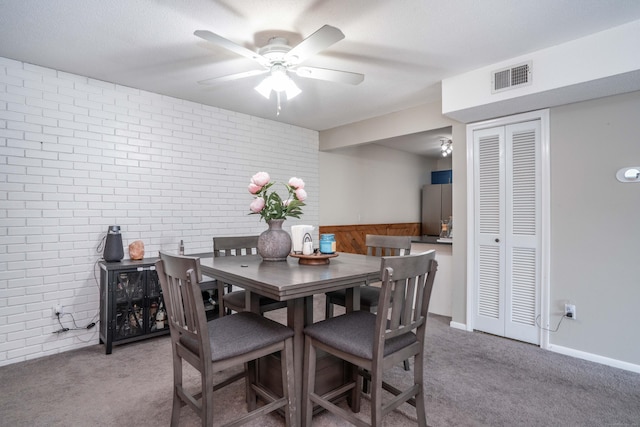 506 Twin Circle Dr Unit 506, South Windsor, CT 06074 - carpeted dining room with brick wall and a ceiling fan