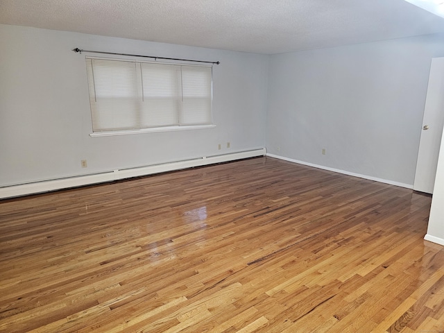 508 Oak Ave Apt 7, Cheshire, CT 06410 - unfurnished room with a baseboard radiator, wood finished floors, and a textured ceiling