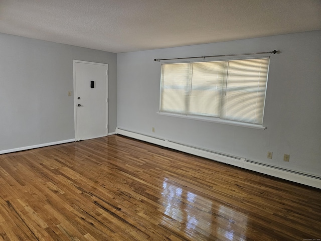 508 Oak Ave Apt 7, Cheshire, CT 06410 - empty room featuring wood finished floors, a baseboard radiator, and a textured ceiling