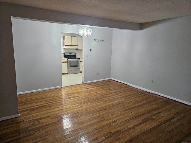508 Oak Ave Apt 7, Cheshire, CT 06410 - spare room with a chandelier, wood finished floors, and a textured ceiling