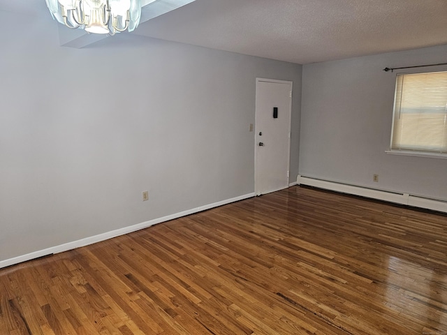 508 Oak Ave Apt 7, Cheshire, CT 06410 - spare room featuring a chandelier, wood finished floors, baseboard heating, and a textured ceiling