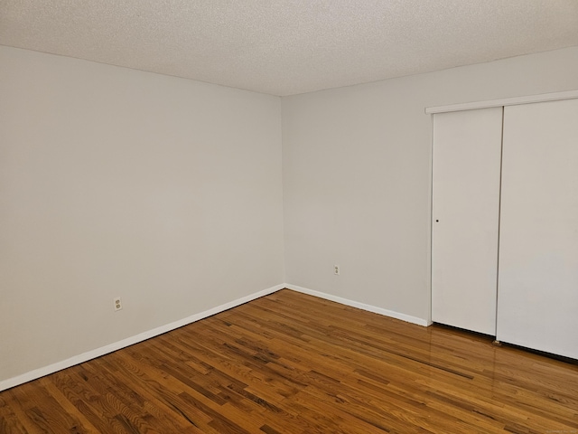 508 Oak Ave Apt 7, Cheshire, CT 06410 - unfurnished bedroom featuring wood finished floors, a textured ceiling, and a closet
