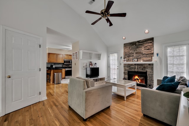 114 Tiffany Ln, Bristol, CT 06010 - living area with high vaulted ceiling, a stone fireplace, a ceiling fan, light wood-type flooring, and recessed lighting