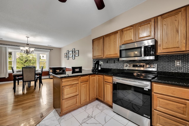 114 Tiffany Ln, Bristol, CT 06010 - kitchen featuring stainless steel appliances, a peninsula, a chandelier, light marble finish flooring, and ceiling fan