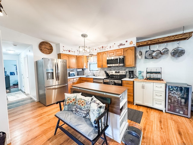 64 Spaulding Rd, Plainfield, CT 06374 - kitchen featuring appliances with stainless steel finishes, light wood-style floors, light countertops, and backsplash
