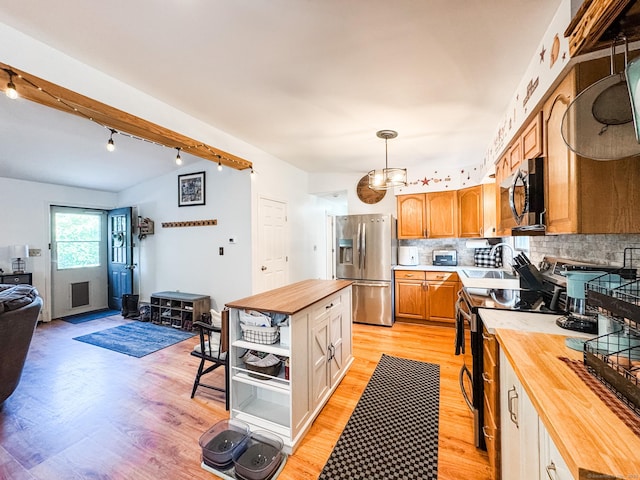 64 Spaulding Rd, Plainfield, CT 06374 - kitchen featuring wooden counters, appliances with stainless steel finishes, light wood-style floors, track lighting, and backsplash