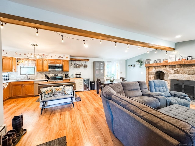 64 Spaulding Rd, Plainfield, CT 06374 - living area featuring track lighting, light wood finished floors, plenty of natural light, and beam ceiling