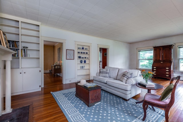 240 Main St, Salisbury, CT 06068 - living area with built in features, dark wood-type flooring, a baseboard heating unit, and ornamental molding