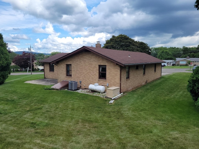 62 Rice Rd, Meriden, CT 06450 - rear view of property featuring a chimney, brick siding, a yard, and roof with shingles