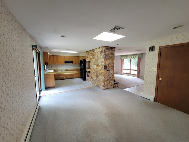 62 Rice Rd, Meriden, CT 06450 - unfurnished living room featuring wallpapered walls, light colored carpet, baseboard heating, and a skylight