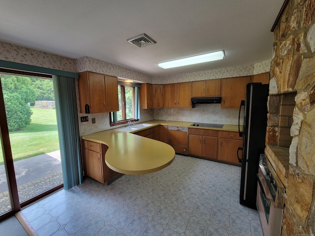 62 Rice Rd, Meriden, CT 06450 - kitchen with wall oven, dishwashing machine, wallpapered walls, under cabinet range hood, and brown cabinetry