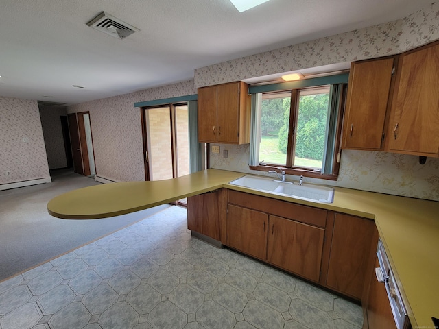 62 Rice Rd, Meriden, CT 06450 - kitchen featuring wallpapered walls, light countertops, brown cabinets, and light floors